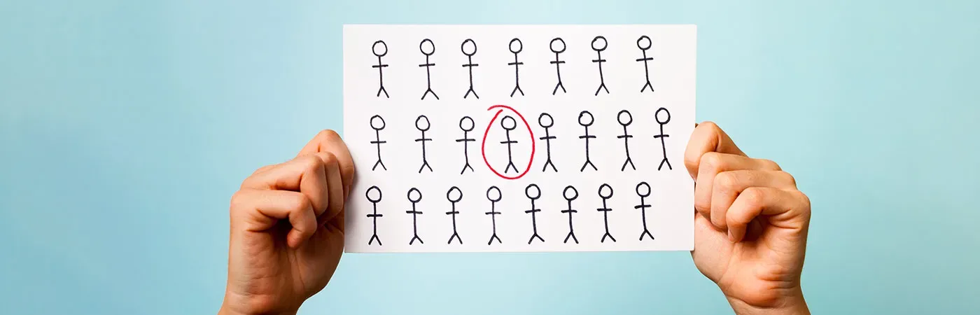 A number of stick figures on a page of paper, one circled in red